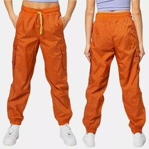 Nike Icon Clash Loose Fit Parachute Joggers In Desert Orange/Lemon Venom